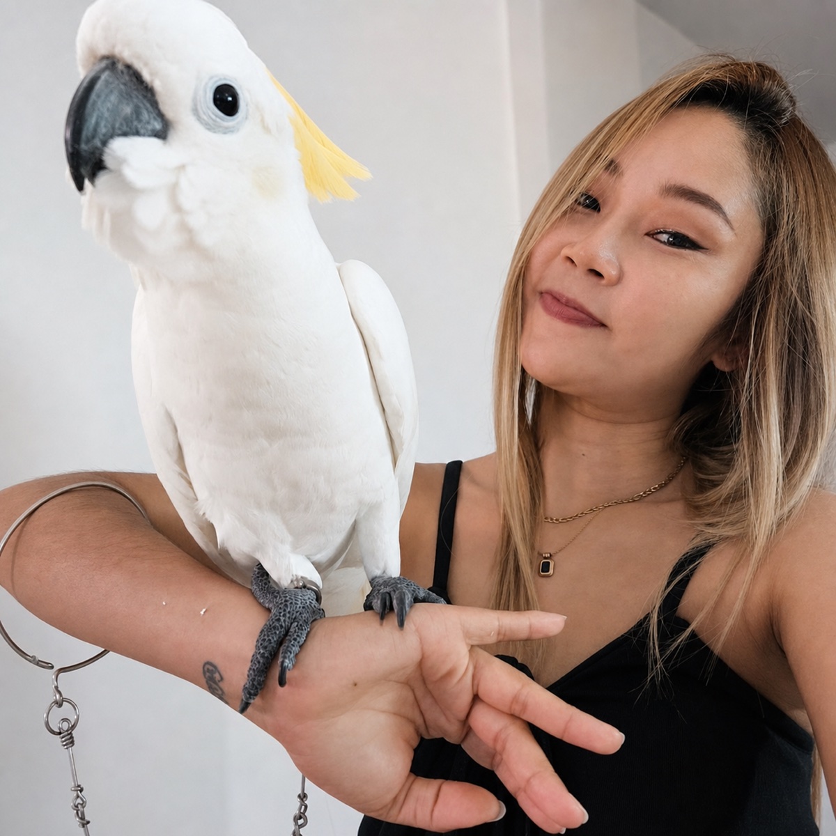 Popcorn, owner of Kamala Scooter Rental, with her cockatoo